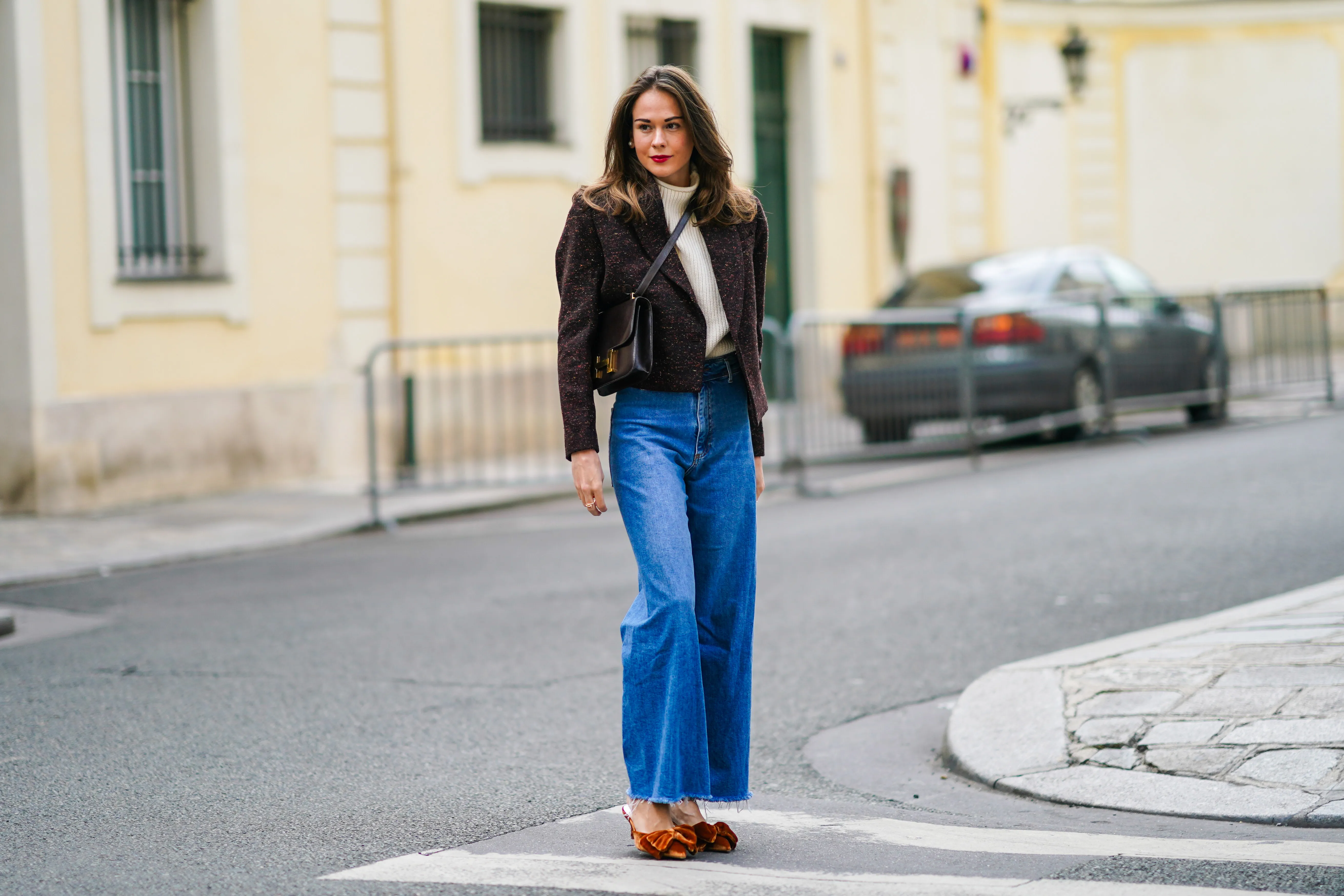 PARIS, FRANCE - OCTOBER 08: Therese Hellstr&ouml;m wears a white wool turtleneck pullover, a brown blazer jacket with shoulder pads from Anine Bing, a Hermes leather bag, blue denim Custommade jeans, brown velvet pointy Custommade shoes with bow tie, on October 08, 2020 in Paris, France. (Photo by Edward Berthelot/Getty Images)