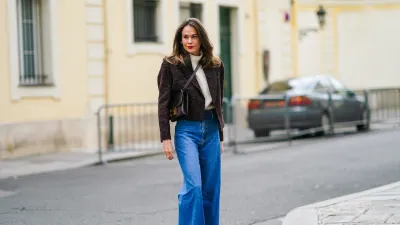 PARIS, FRANCE - OCTOBER 08: Therese Hellström wears a white wool turtleneck pullover, a brown blazer jacket with shoulder pads from Anine Bing, a Hermes leather bag, blue denim Custommade jeans, brown velvet pointy Custommade shoes with bow tie, on October 08, 2020 in Paris, France. (Photo by Edward Berthelot/Getty Images)