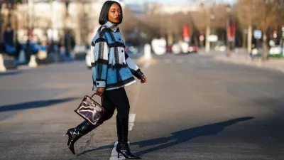 PARIS, FRANCE - JANUARY 09: Carrole Sagba aka "Linaose" wears a blue and white checked wool jacket from Zara, a purple / burgundy leather Hermes Birkin bag, black leggings/pants from Acne Studios, black pointy high heeled knee-high leather boots with printed crocodile patterns from Dear Frances, on January 09, 2021 in Paris, France. (Photo by Edward Berthelot/Getty Images)