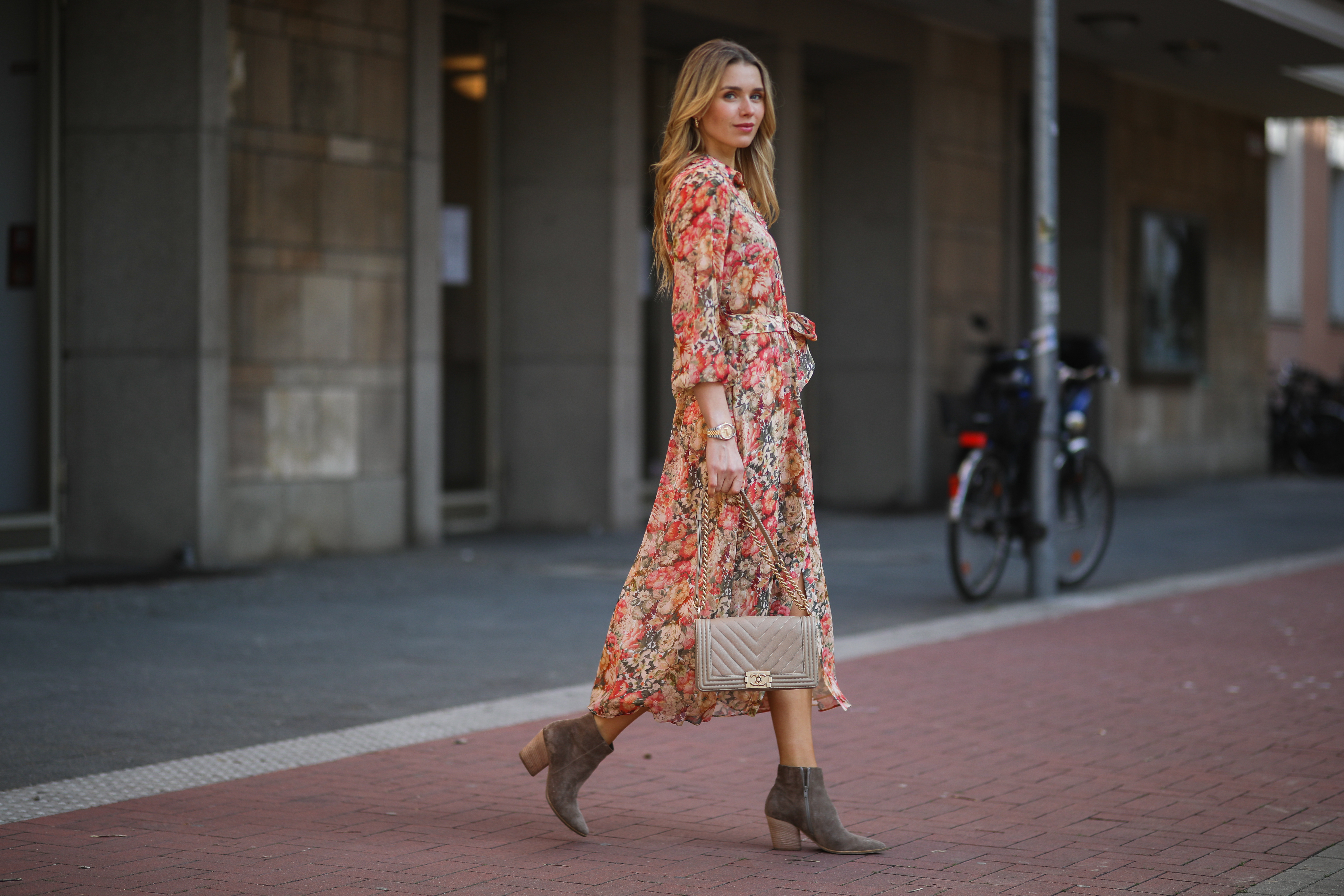 DUSSELDORF, GERMANY - MARCH 24: Scarlett Gartmann wearing Mango flower dress, beige Chanel Boy bag and brown Kennel & Schmenger leather boots on March 24, 2021 in Dusseldorf, Germany. (Photo by Jeremy Moeller/Getty Images)