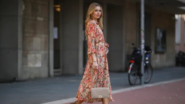 DUSSELDORF, GERMANY - MARCH 24: Scarlett Gartmann wearing Mango flower dress, beige Chanel Boy bag and brown Kennel & Schmenger leather boots on March 24, 2021 in Dusseldorf, Germany. (Photo by Jeremy Moeller/Getty Images)