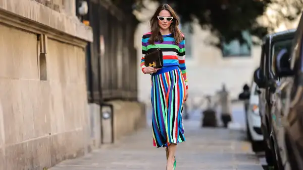 PARIS, FRANCE - APRIL 08: Therese Hellström @tesshell wears white cat-eye sunglasses, a multi colored striped wool midi dress with long sleeves, a brown leather Hermes bag, green pointed shoes with metallic pearls, on April 08, 2021 in Paris, France. (Photo by Edward Berthelot/Getty Images)