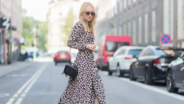COPENHAGEN, DENMARK - AUGUST 09: Juliane Diesner wearing Ganni dress with floral print, Chanel bag, Balenciaga boots on August 09, 2017 in Copenhagen, Denmark. (Photo by Christian Vierig/Getty Images)