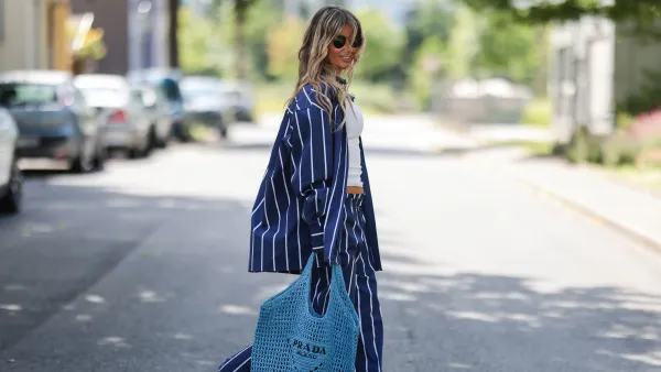 DUSSELDORF, GERMANY - JUNE 12: Gitta Banko seen wearing a Ray Ban sunglasses, a white tank top, a blue/white striped cotton pyjama set from Yaitte, rhinestone sandals from Aminah Abdul Jillil and a blue bast raffia tote bag from Prada on June 12, 2022 in Dusseldorf, Germany. (Photo by Jeremy Moeller/Getty Images)
