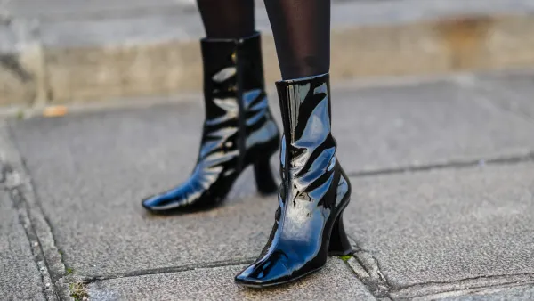 PARIS, FRANCE - DECEMBER 11: Emilie Joseph @in_fashionwetrust wears black tights, black shiny leather / vinyle heels ankle boots with square toe-cap, during a street style fashion photo session, on December 11, 2021 in Paris, France. (Photo by Edward Berthelot/Getty Images)