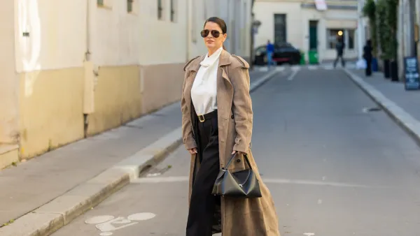 PARIS, FRANCE - SEPTEMBER 29: Gili Biegun wears extra long beige suede coat, snake leather boots, black leather Toteme T lock bag, black trousers and white Silk Turtle neck blouseduring the Womenswear Spring Summer 2026 as part of Paris Fashion Week on September 29, 2025 in Paris, France. (Photo by Christian Vierig/Getty Images)