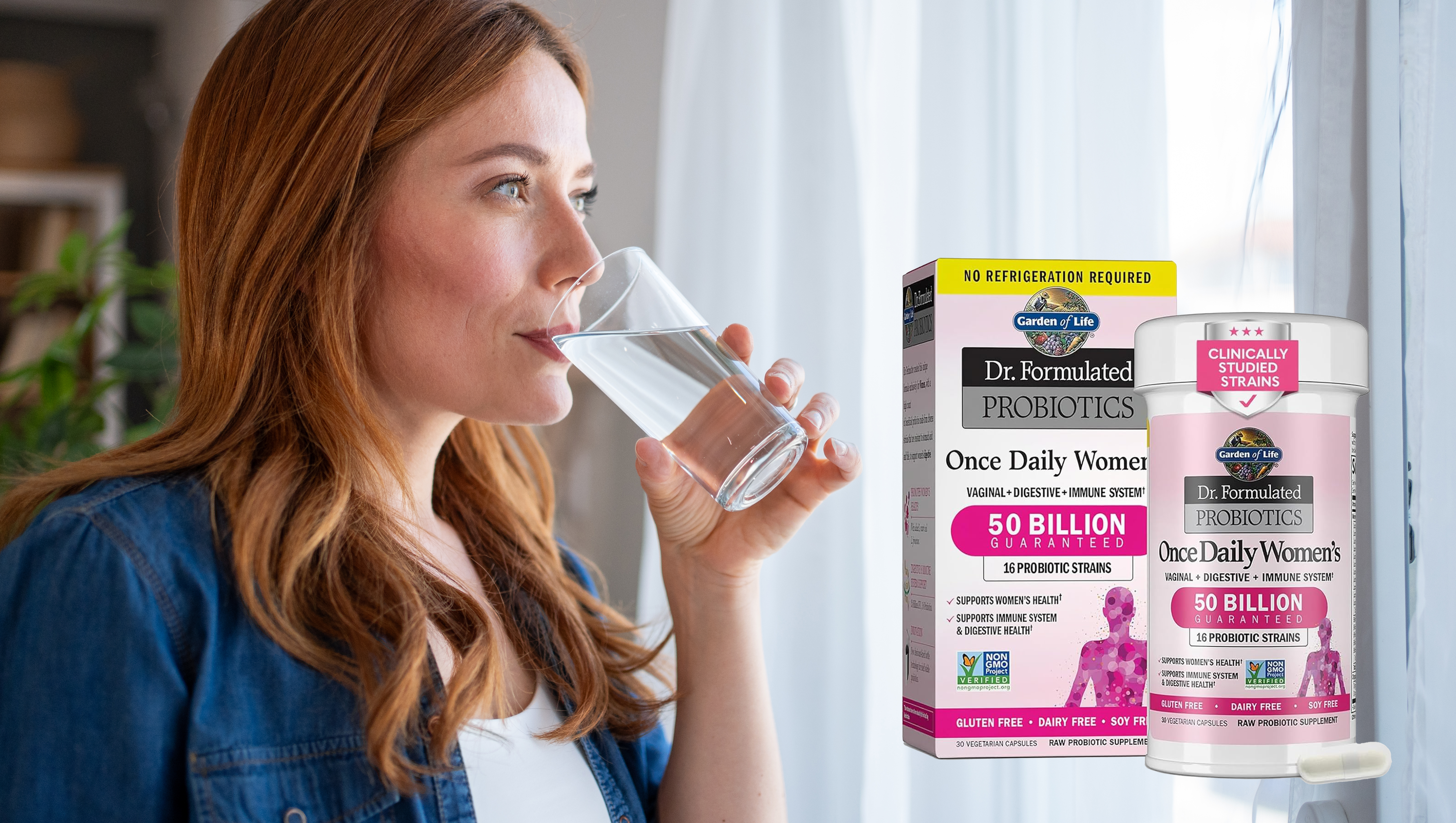 Mid adult woman enjoying a glass of fresh water while standing by the window at home, gazing outside and savoring a peaceful moment of relaxation and hydration