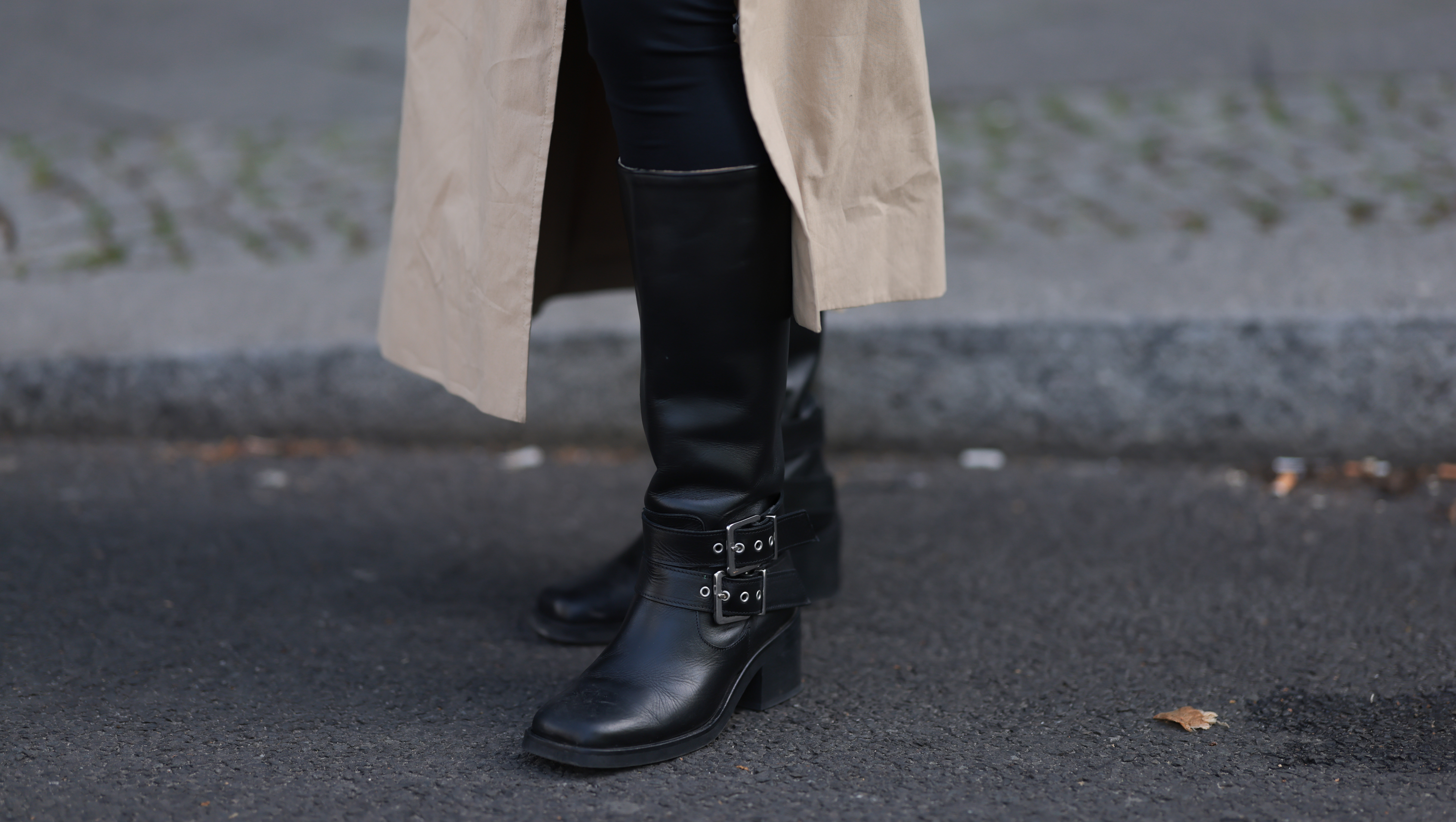 BERLIN, GERMANY - APRIL 17: Sophia Geiss seen wearing LeGer black cotton form-fitting leggings, Cos long, beige oversized trench coat with oversized lapels and a relaxed structure and & Other Stories black leather knee-high boots with a modest heel, adding a bit of edge and sophistication, on April 17, 2025 in Berlin, Germany. (Photo by Jeremy Moeller/Getty Images)