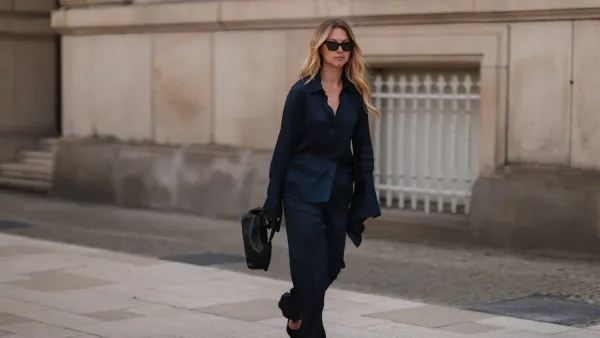 HAMBURG, GERMANY - JUNE 09: Liesa Späht seen wearing black sunglasses from Celine, a dark blue silk blouse from SoSue, a matching dark blue silk wide leg pants from SoSue, black heels from Saint Laurent and a black leather Khaite bag on June 09, 2022 in Hamburg, Germany. (Photo by Jeremy Moeller/Getty Images)