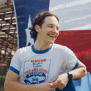 Jack Blocker posing in front of a Texas flag.