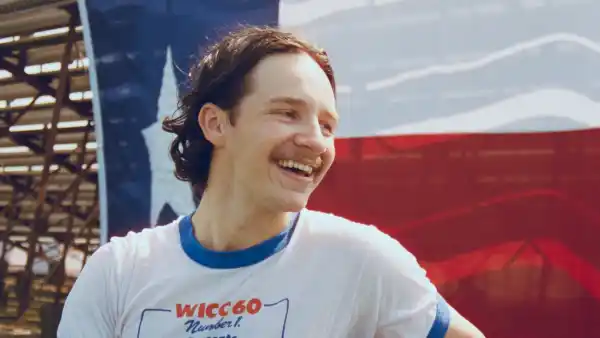 Jack Blocker posing in front of a Texas flag.
