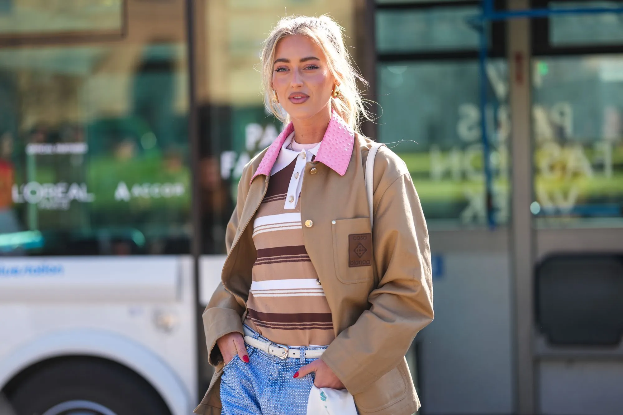 PARIS, FRANCE - MARCH 05: Emili Sindlev wears gold earrings, light pink t-shirt, light brown dark brown white striped polo shirt, dark brown dark pink leather collar oversized Casablanca jacket, outside Casablanca, during the Paris Fashion week Women's Fall/Winter 2025-2026 on March 5, 2025 in Paris, France. (Photo by Edward Berthelot/Getty Images)