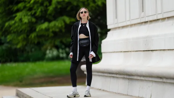 PARIS, FRANCE - MAY 12: Emy Venturini wears sunglasses from Ray Ban, a necklace, a white shirt from Louis Vuitton, a black Zara crop top, a black oversize blazer jacket from The Frankie Shop, black leggings from Intimissimi, white socks from Calzedonia, Nike sneakers shoes, a black leather belt bag / fanny pack from Patagonia, during a street style fashion photo session, on May 12, 2024 in Paris, France. (Photo by Edward Berthelot/Getty Images)