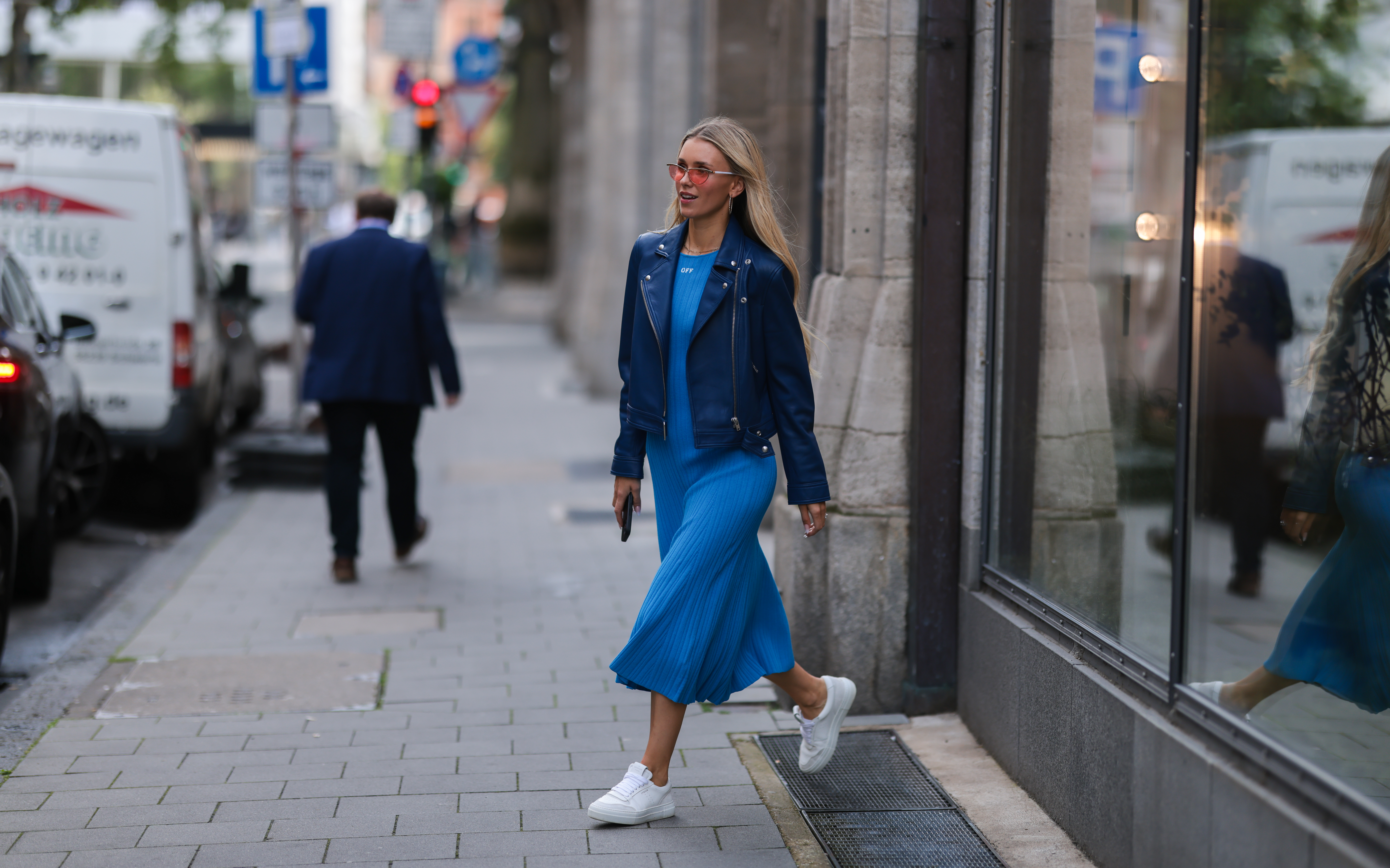 DUSSELDORF, GERMANY - JUNE 13: Scarlett Gartmann-Reus seen wearing a red sunglasses, a blue midi dress from Off White, a blue leather jacket from Iro Paris and white leather sneakers from Copenhagen Studios on June 13, 2022 in Dusseldorf, Germany. (Photo by Jeremy Moeller/Getty Images)