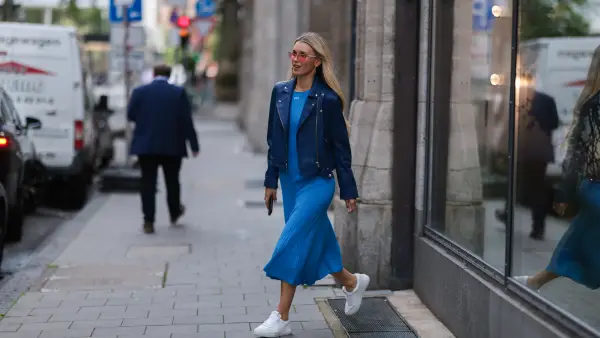DUSSELDORF, GERMANY - JUNE 13: Scarlett Gartmann-Reus seen wearing a red sunglasses, a blue midi dress from Off White, a blue leather jacket from Iro Paris and white leather sneakers from Copenhagen Studios on June 13, 2022 in Dusseldorf, Germany. (Photo by Jeremy Moeller/Getty Images)