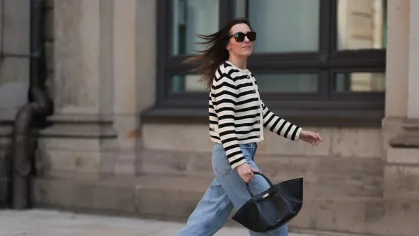 Elise Seitz seen wearing Bottega Veneta black shades, Celine black belt, Adidas black samba sneaker, Agolde blue jeans, Massimo Dutti striped black and white cardigan and Demellier black bag on May 09, 2023 in Hamburg, Germany.
