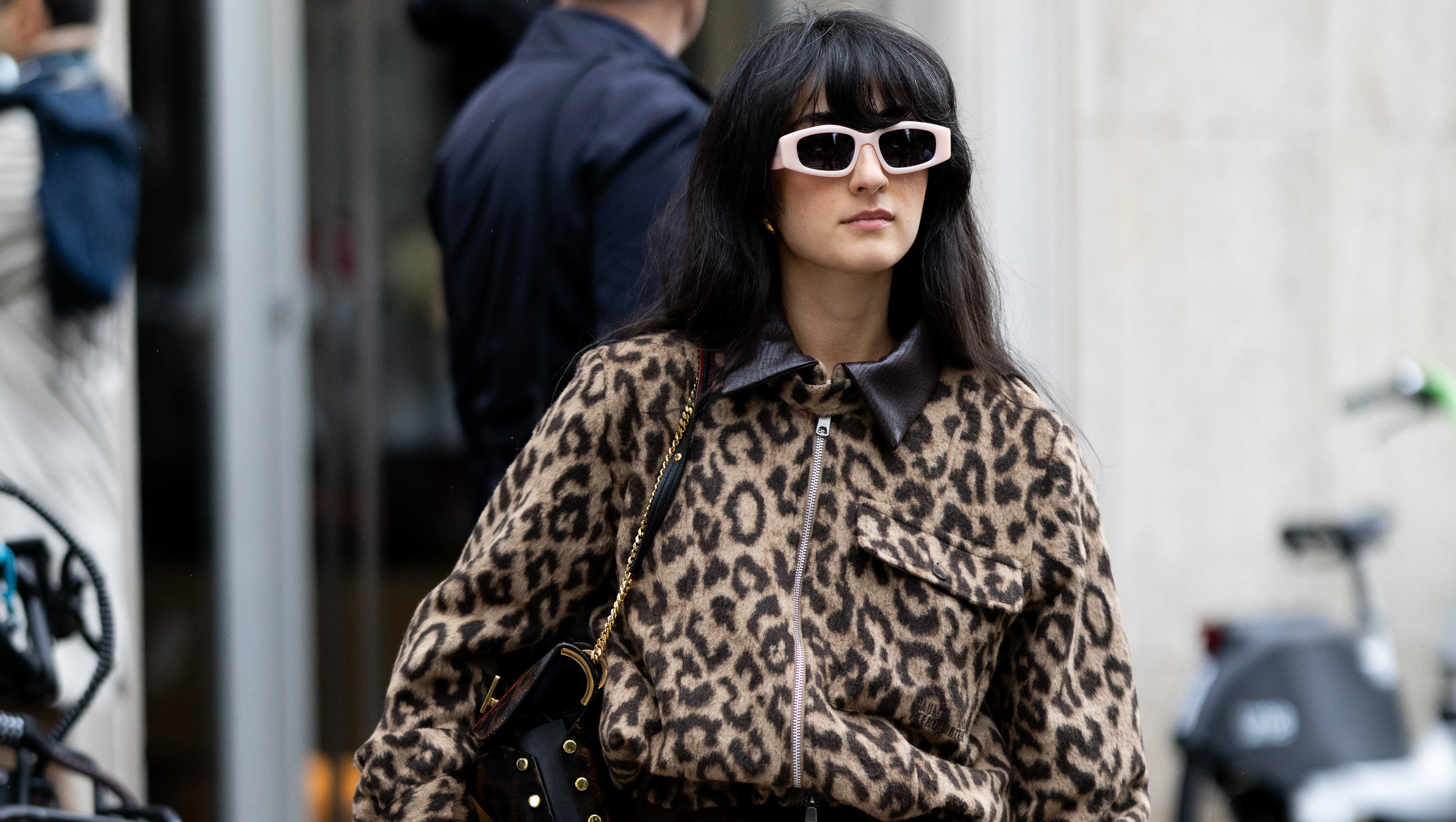 MILAN, ITALY - SEPTEMBER 27: A guest wears brown trousers, beige sunglasses, a leopard printed cargo cropped jacket, a brown silk skirt and a black leather bag outside Dolce & Gabbana show during the Milan Fashion Week Womenswear Spring/Summer 2026 on September 27, 2025 in Milan, Italy. (Photo by Valentina Frugiuele/Getty Images)