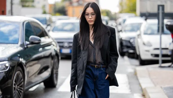 MILAN, ITALY - SEPTEMBER 27: Jenny Tsang wears black blazer, flared denim jeans, bag, blouse outside Bottega Veneta during the Milan Fashion Week Womenswear Spring/Summer 2026 on September 27, 2025 in Milan, Italy. (Photo by Christian Vierig/Getty Images)