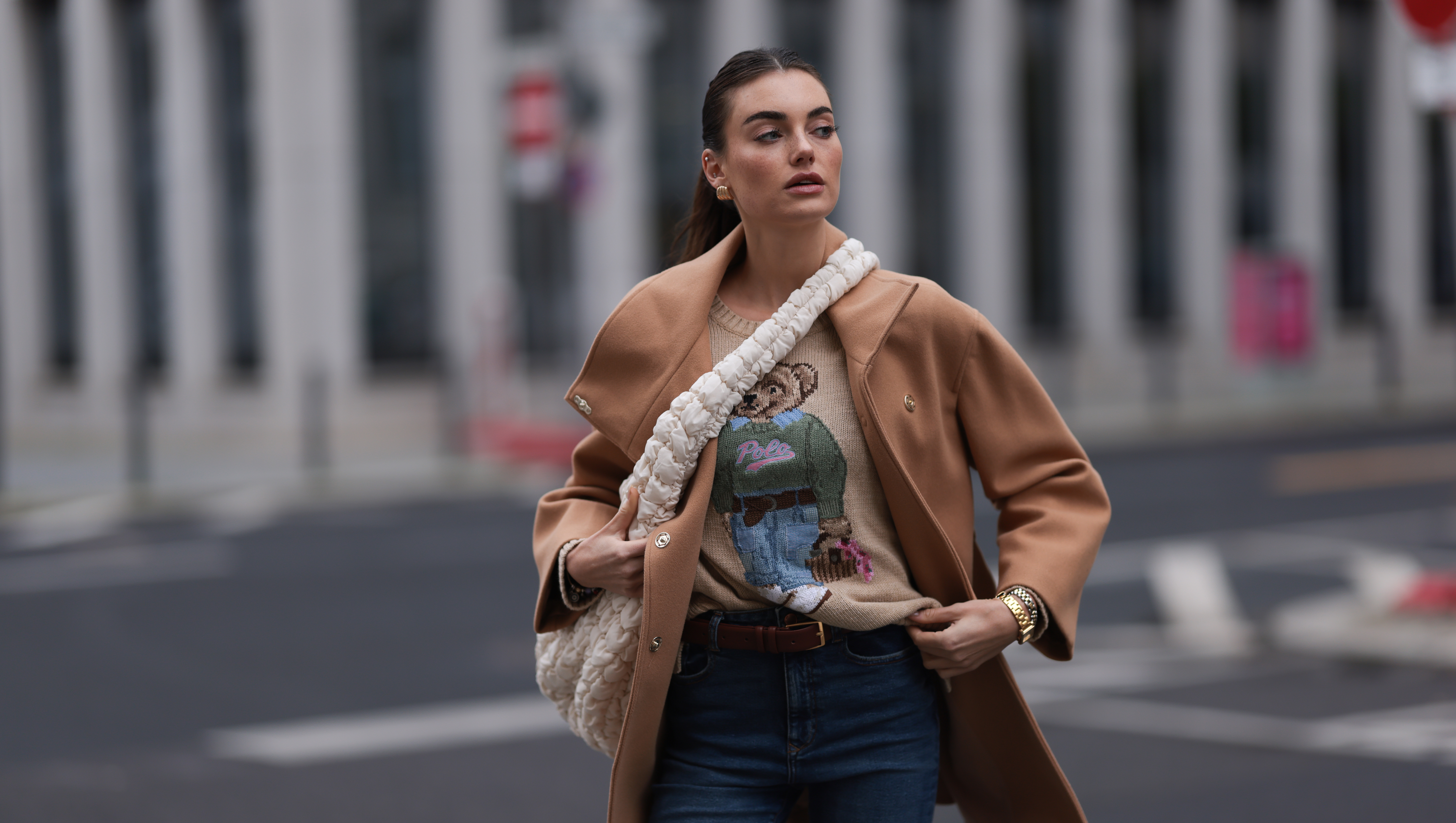 BERLIN, GERMANY - NOVEMBER 09: Celine Bethmann seen wearing gold earrings, Ralph Lauren beige wool teddy knit sweater, Liu Jo brown wool short coat, COS cream white crossbody bag, Zara blue denim jeans / pants, on November 09, 2023 in Berlin, Germany. (Photo by Jeremy Moeller/Getty Images)