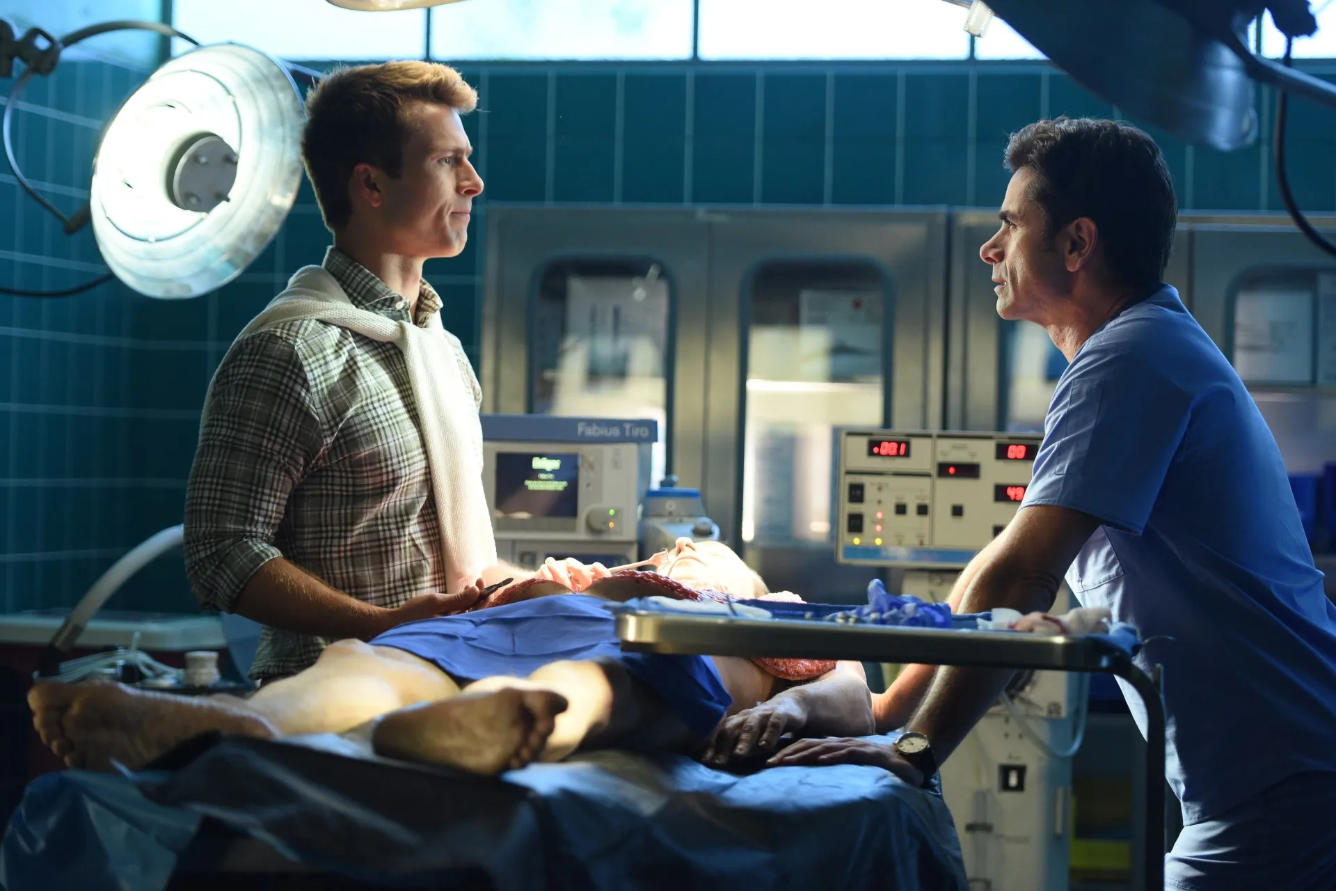 Glen Powell and John Stamos in Scream Queens season 2