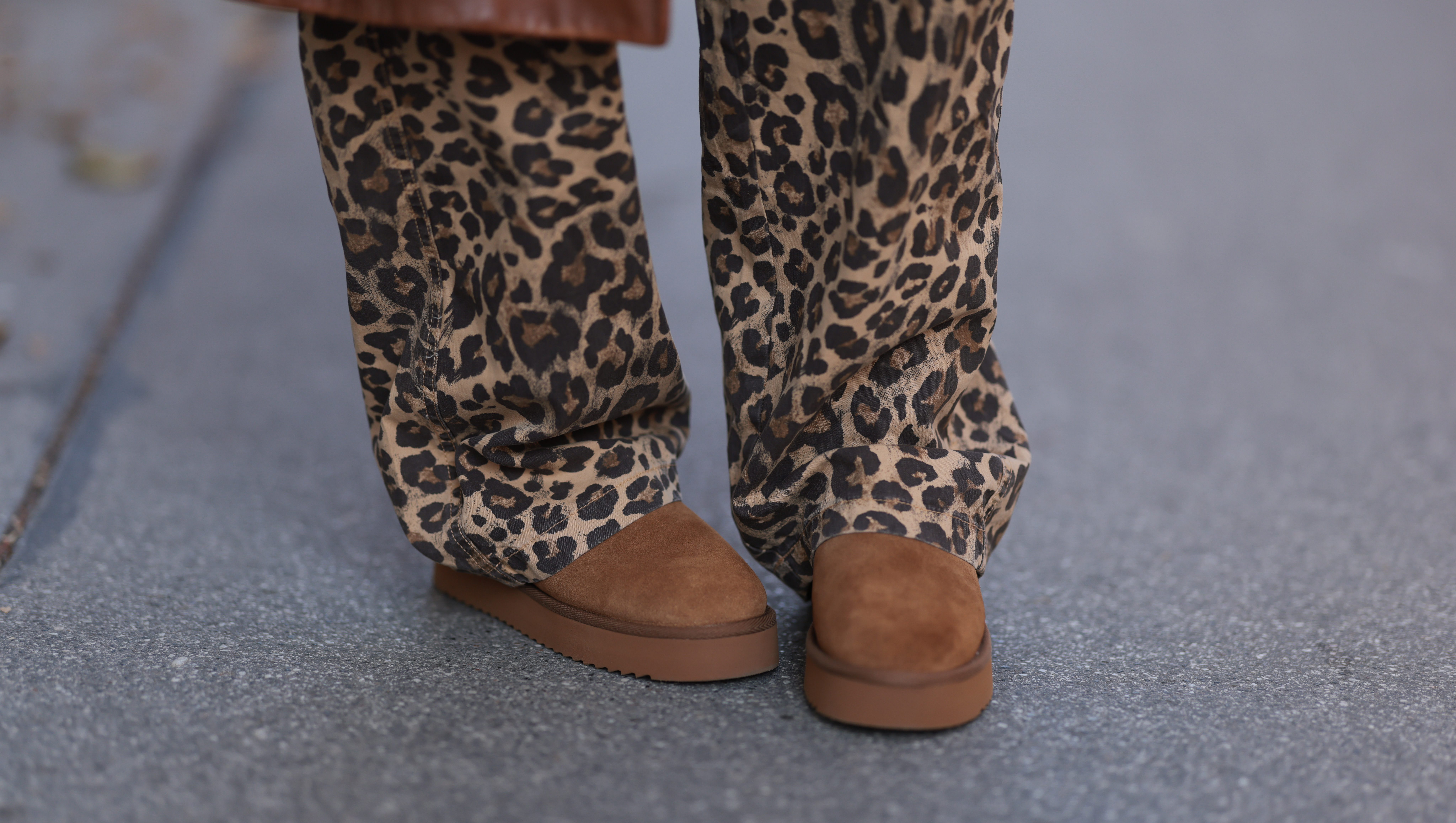 VIENNA, AUSTRIA - NOVEMBER 05: Karin Teigl is seen wearing a calf-length brown leather coat from Prada, wide jeans in leopard print from Bershka, and brown suede platform slippers from Copenhagen Studios on November 05, 2024 in Vienna, Austria. (Photo by Jeremy Moeller/Getty Images)