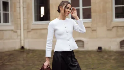 PARIS, FRANCE - MARCH 10: Bambi Northwood-Blyth wears black leather pants, white jacket with buttons and brown Loewe bag outside the LOEWE presentation during the Womenswear Fall/Winter 2025/2026 as part of Paris Fashion Week on March 10, 2025 in Paris, France. (Photo by Raimonda Kulikauskiene/Getty Images)