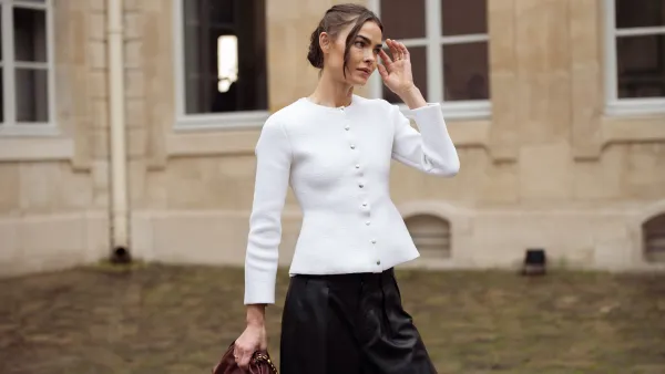 PARIS, FRANCE - MARCH 10: Bambi Northwood-Blyth wears black leather pants, white jacket with buttons and brown Loewe bag outside the LOEWE presentation during the Womenswear Fall/Winter 2025/2026 as part of Paris Fashion Week on March 10, 2025 in Paris, France. (Photo by Raimonda Kulikauskiene/Getty Images)