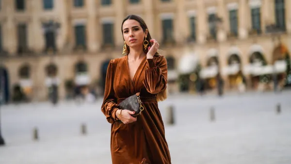 PARIS, FRANCE - DECEMBER 04: Maria Rosaria Rizzo wears golden long earrings from Raspini, a brown fluffy long winter coat from Max Mara, a brown leather monogram Vuitton bag, a brown velvet low-neck v-neck dress with lace and floral embroidery on the bottom part from Imprevu, on December 04, 2020 in Paris, France. (Photo by Edward Berthelot/Getty Images)