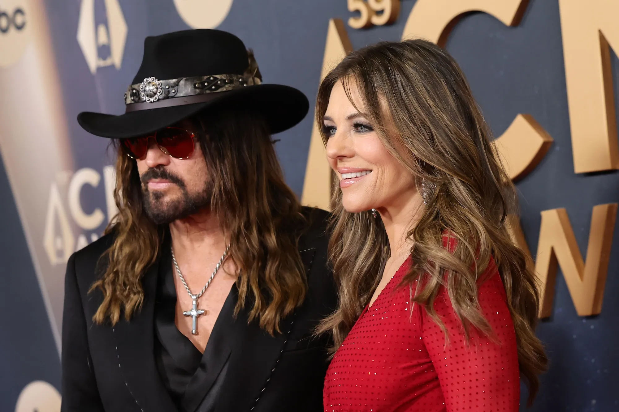Billy Ray Cyrus and Elizabeth Hurley Hold Hands on Red Carpet Before Presenting at 2025 CMA Awards GettyImages-2247543671