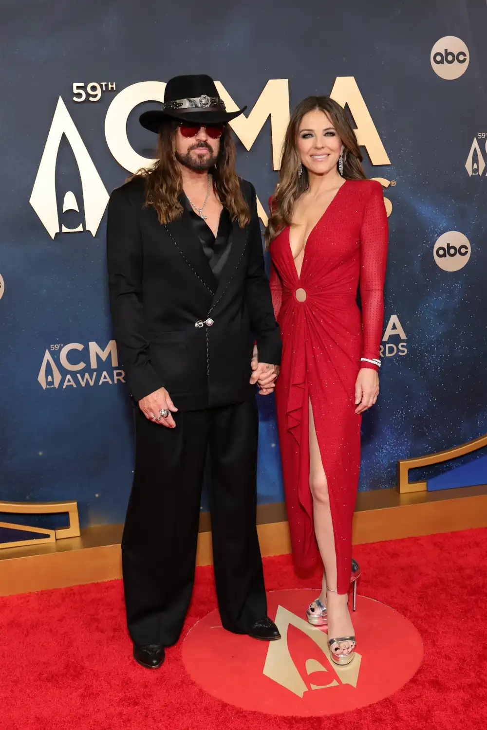 Billy Ray Cyrus and Elizabeth Hurley Hold Hands on Red Carpet Before Presenting at 2025 CMA Awards inline GettyImages-2247542861