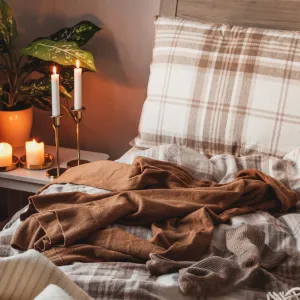 Cozy flannel sheets stacked neatly on a bed for winter comfort.