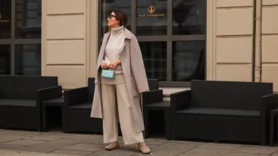 Elise Soho wearing Birkenstock beige sandals, Joseph beige two piece, Nanushka beige coat, Loewe mini blue baby bag on August 30, 2021 in Hamburg, Germany.