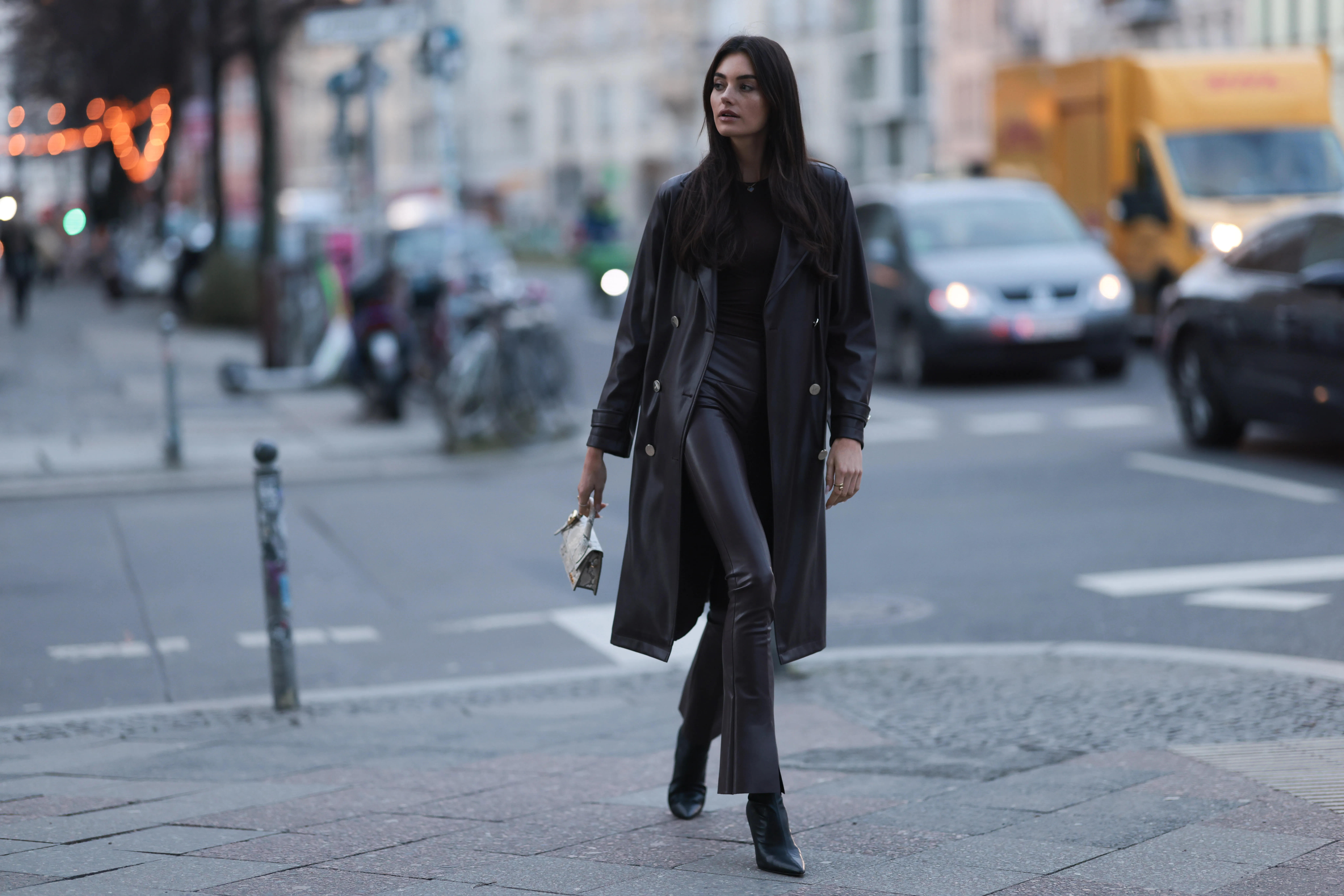 BERLIN, GERMANY - FEBRUARY 13: Celine Bethmann seen wearing Van Cleef & Arpels gold / black necklace, gold earrings, Norma Kamali brown cotton long sleeve top, Norma Kamali brown leather wide leg pants / leggings pants, Liu Jo brown leather midi length coat, Jacquemus Le Chiquito long beige leather crocodile print pattern bag and Liu Jo black leather heeled ankle boots, on February 13, 2024 in Berlin, Germany. (Photo by Jeremy Moeller/Getty Images)