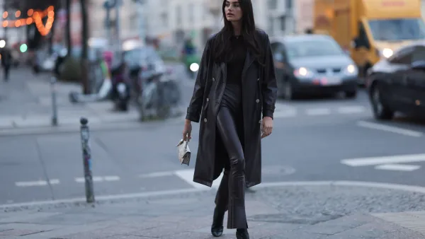 BERLIN, GERMANY - FEBRUARY 13: Celine Bethmann seen wearing Van Cleef & Arpels gold / black necklace, gold earrings, Norma Kamali brown cotton long sleeve top, Norma Kamali brown leather wide leg pants / leggings pants, Liu Jo brown leather midi length coat, Jacquemus Le Chiquito long beige leather crocodile print pattern bag and Liu Jo black leather heeled ankle boots, on February 13, 2024 in Berlin, Germany. (Photo by Jeremy Moeller/Getty Images)