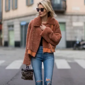 MILAN, ITALY - FEBRUARY 26: Lisa Hahnbueck wearing Designers Remix Candy Coat Boxy Shearling Coat with large collar and zipper, Citizens of Humanity jeans, OF HUMANITY JEANS, Louis Vuitton Star Trail ankle boot, Louis Vuitton Supple Rigid bag in Monogram canvas, Prada Sunglasses during Milan Fashion Week Fall/Winter 2017/18 on February 26, 2017 in Milan, Italy. (Photo by Christian Vierig/Getty Images)
