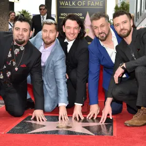 Chris Kirkpatrick, Lance Bass, JC Chasez, Joey Fatone and Justin Timberlake of 'NSync pose with their star on the Hollywood Walk of Fame.