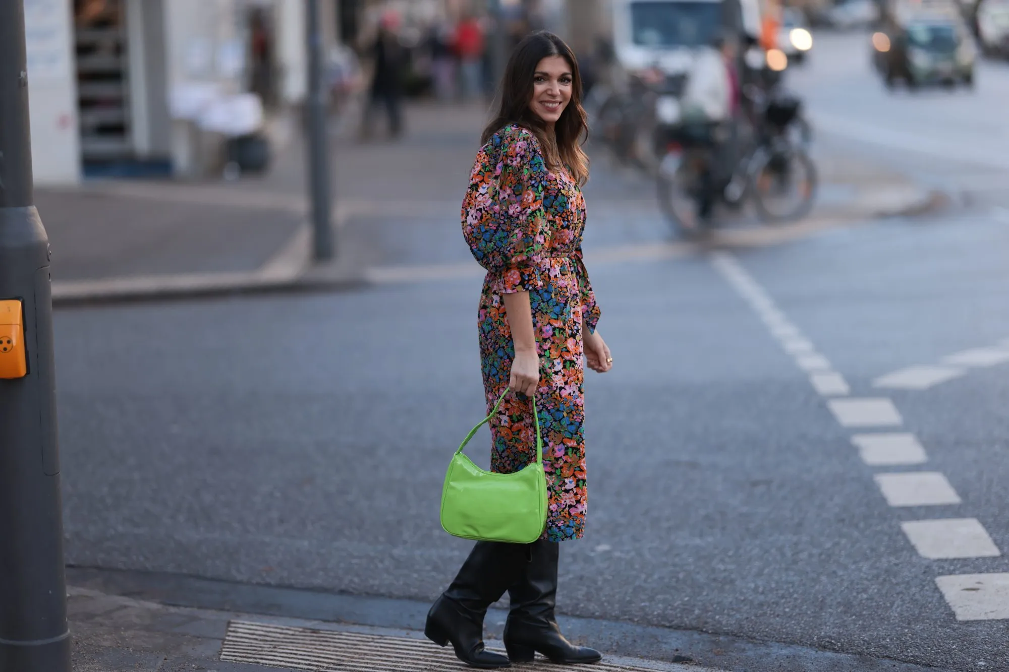 HAMBURG, GERMANY - DECEMBER 09: Anna Wolfers seen wearing a flower patterned dress with puffed sleeves, a neon green bag and black cowboy boots on December 09, 2022 in Hamburg, Germany. (Photo by Jeremy Moeller/Getty Images)