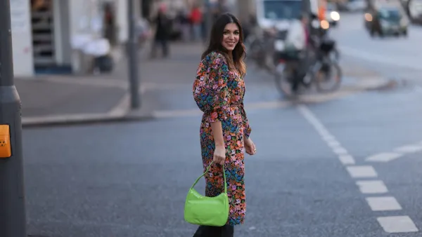 HAMBURG, GERMANY - DECEMBER 09: Anna Wolfers seen wearing a flower patterned dress with puffed sleeves, a neon green bag and black cowboy boots on December 09, 2022 in Hamburg, Germany. (Photo by Jeremy Moeller/Getty Images)
