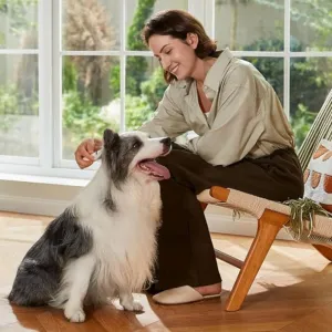 Woman using a Eureka Robot Vacuum in living room