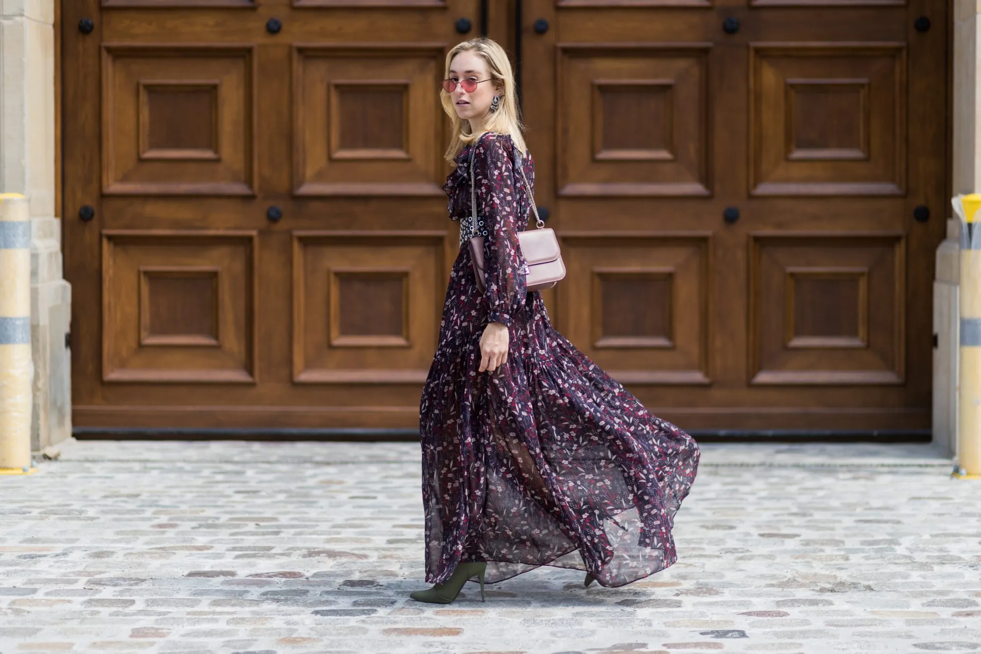 BERLIN, GERMANY - AUGUST 01: Sonia Lyson wearing a boho dress with long sleeves from Tara Jarmon, vintage belt, pink Valentino bag, olive green heeled boots Topshop, pink Vogue x Gigi Hadid sunglasses on August 1, 2017 in Berlin, Germany. (Photo by Christian Vierig/Getty Images)