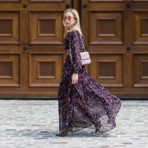 BERLIN, GERMANY - AUGUST 01: Sonia Lyson wearing a boho dress with long sleeves from Tara Jarmon, vintage belt, pink Valentino bag, olive green heeled boots Topshop, pink Vogue x Gigi Hadid sunglasses on August 1, 2017 in Berlin, Germany. (Photo by Christian Vierig/Getty Images)
