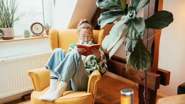 Woman staying cozy with a Dreo space heater