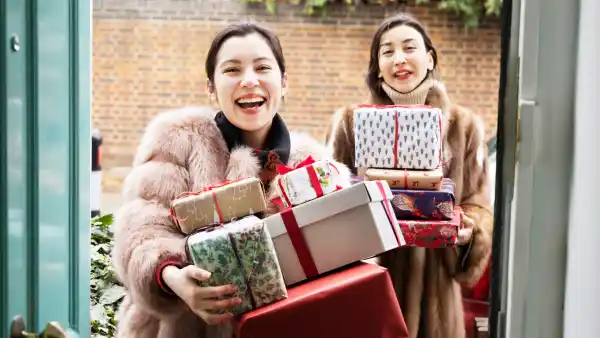 Woman shopping for holiday gifts online and bringing them to a party