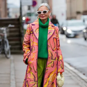 COPENHAGEN, DENMARK - FEBRUARY 02: Grece Ghanem is seen wearing pink coat with print, green turtleneck, green Stine Goya outside Stine Goya during Copenhagen Fashion Week Autumn/Winter 2022 on February 02, 2022 in Copenhagen, Denmark. (Photo by Christian Vierig/Getty Images)