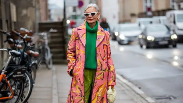 COPENHAGEN, DENMARK - FEBRUARY 02: Grece Ghanem is seen wearing pink coat with print, green turtleneck, green Stine Goya outside Stine Goya during Copenhagen Fashion Week Autumn/Winter 2022 on February 02, 2022 in Copenhagen, Denmark. (Photo by Christian Vierig/Getty Images)