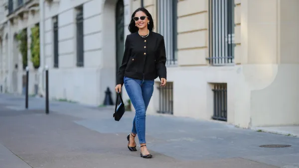 PARIS, FRANCE - JANUARY 07: Patricia Gloria Conteras wears black and white sunglasses, silver Chanel earrings, a pearl necklace, a black jacket with gold buttons, blue denim jeans / pants, a black leather bag, black leather ballerinas shoes, during a street style fashion photo session, on January 07, 2025 in Paris, France. (Photo by Edward Berthelot/Getty Images)