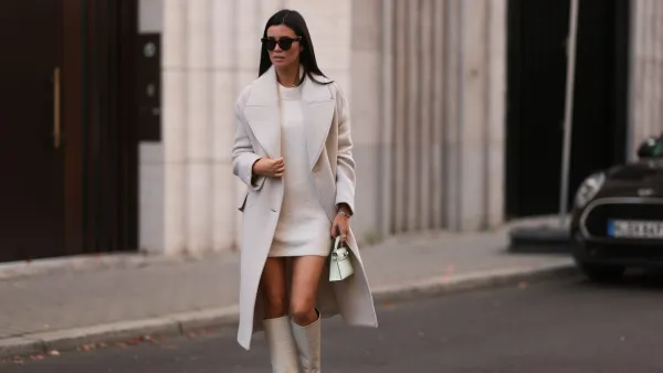 BERLIN, GERMANY - OCTOBER 28: Leo Eberlin wearing Zara beige coat, H&M beige knit sweater dress, Hermes light green mini leather Kelly bag, Paris Texas beige leather boots, Celine brown shades and Leo Mathild jewelry on October 28, 2022 in Berlin, Germany. (Photo by Jeremy Moeller/Getty Images)