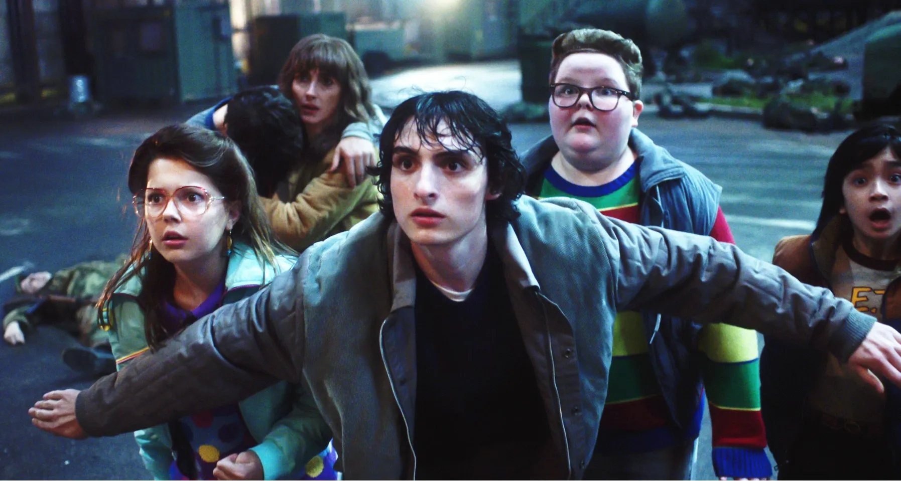 Winona Ryder as Joyce Byers, Finn Wolfhard as Mike Wheeler and Jake Connelly as Derek in Stranger Things season 4