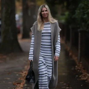 HAMBURG, GERMANY - NOVEMBER 17: Vanessa Giers seen wearing SoSUE Laura black and white knit dress ,SoSUE Knit Cosy Azteco beige vest, Naditum black leather handbag, & other stories black boots on November 17, 2022 in Hamburg, Germany. (Photo by Jeremy Moeller/Getty Images)