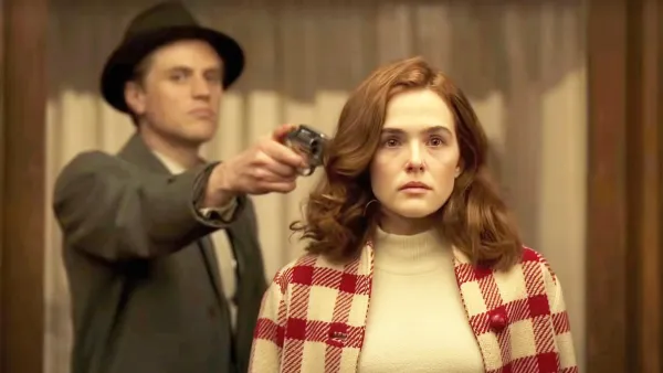 Johnny Flynn, Zoey Deutch in The Outfit